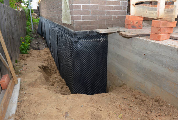 Happy homeowners after waterproofing job in Randolph
